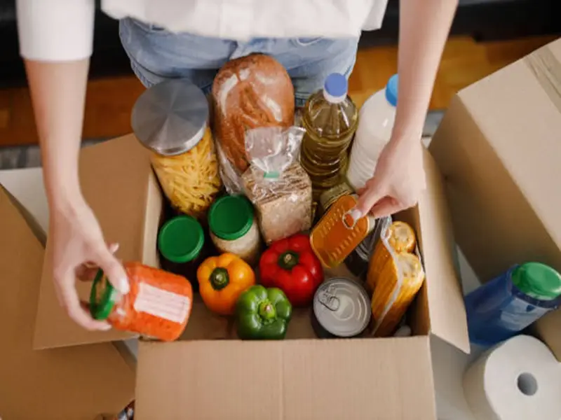 Details of Volunteer with box of food for poor